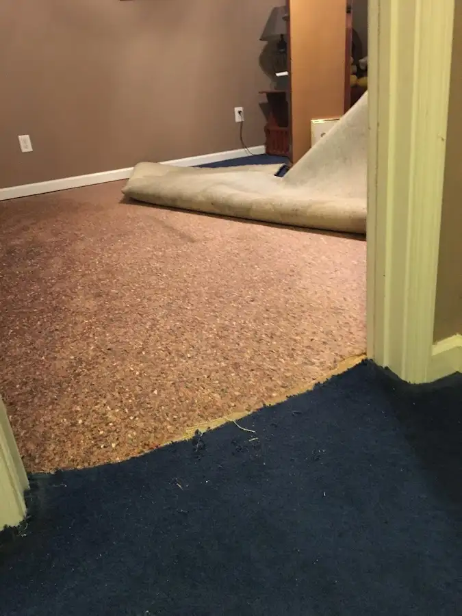Carpet pad removal revealing water damage during Water Mitigation Services in Center Point